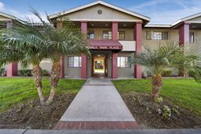 Buena Park apartment for rent - The front of a building with a red brick pathway leading to the entrance.