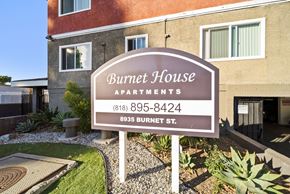 North Hills apartment for rent - A sign for Burnet House Apartments is in front of a building.