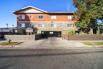 North Hills apartment for rent - The image shows a multi-story building with a brown and beige facade, a black gate, and a sign that reads "Marriott Hotel."