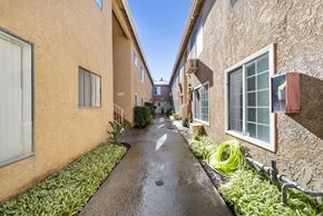N. Hollywood apartment for rent - A long, narrow pathway leads between two rows of houses.