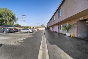 N. Hollywood apartment for rent - A parking lot with cars parked and a building on the right side.