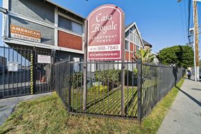 Van Nuys apartment for rent - A sign for Casa Royale Apartments is displayed in front of a fence.