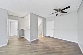 Van Nuys apartment for rent - A spacious room with a ceiling fan and light wood flooring.