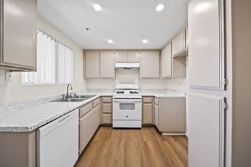 Fontana apartment for rent - A kitchen with white appliances and wooden floors.