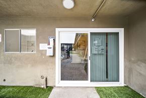 Sun Valley apartment for rent - A white door with a glass window is open to a backyard.