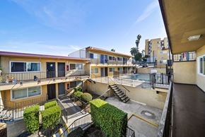Los Angeles apartment for rent - Apartment complex with a pool and greenery.