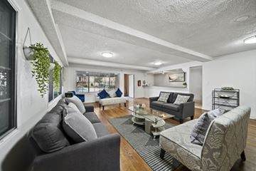 Van Nuys apartment for rent - A living room with grey couches and a coffee table.