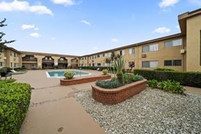 Van Nuys apartment for rent - A courtyard with a pool and a small garden.