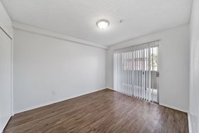 Los Angeles apartment for rent - A room with wooden flooring and white walls.