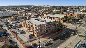 Los Angeles apartment for rent - A view of a city from a high vantage point with buildings, cars, and a clear sky.
