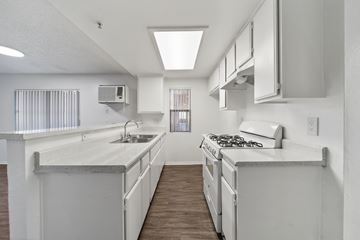 Los Angeles apartment for rent - A white kitchen with a stove top oven and a sink.