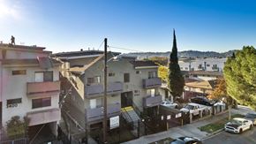 Los Angeles apartment for rent - A sunny day in a residential area with cars parked on the street.