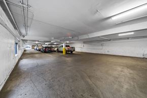 Los Angeles apartment for rent - A parking garage with a concrete floor and white walls.
