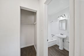 Buena Park apartment for rent - A white bathroom with a sink and a mirror.