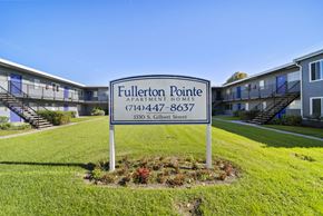Fullerton apartment for rent - A sign for Fullerton Pointe Apartment Homes stands in front of apartment buildings.