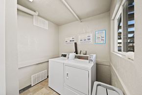 Fullerton apartment for rent - A washing machine is sitting in a small room.