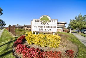 Hemet apartment for rent - A sign for Green Tree Park in West Devonshire with a phone number on it.