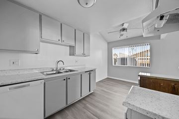 Hemet apartment for rent - A kitchen with white cabinets and a marble countertop.
