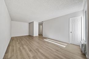 Hollywood apartment for rent - A room with light wood flooring and white walls.