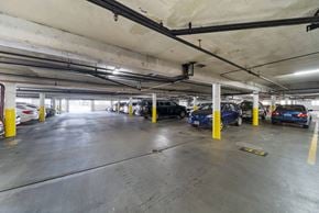 Hollywood apartment for rent - A parking garage with cars parked and yellow poles.