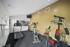 Tehachapi apartment for rent - A gym with a treadmill, weights, and other exercise equipment.
