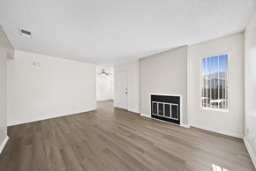 Tehachapi apartment for rent - A room with a fireplace and a window overlooking a cityscape.