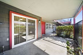 Hemet apartment for rent - A red door with a glass window is on the left side of the image.
