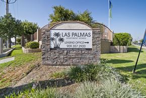Rialto apartment for rent - A sign for Las Palmas Apartment Homes with a phone number and address.