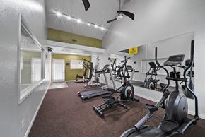 Rialto apartment for rent - A gym with a variety of exercise equipment including treadmills, stationary bikes, and weight machines.