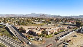 Perris apartment for rent - A road with a car driving on it.