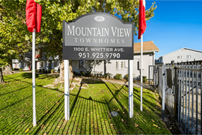 Hemet apartment for rent - A sign for Mountain View Townhomes stands in front of a building.