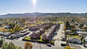 Hemet apartment for rent - A sunny day in a residential area with houses and trees.