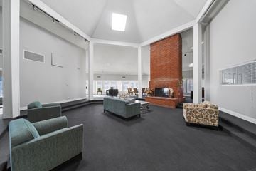Palmdale apartment for rent - A living room with a grey couch and a red brick fireplace.