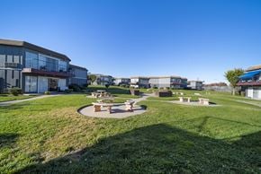 Palmdale apartment for rent - A sunny day at a park with picnic tables and a grassy area.