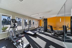 Palmdale apartment for rent - A gym with a row of treadmills and exercise bikes.