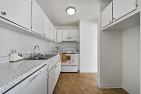 Palmdale apartment for rent - A kitchen with white cabinets and a granite countertop.