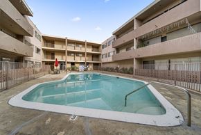Panorama City apartment for rent - A small pool in a courtyard surrounded by buildings.