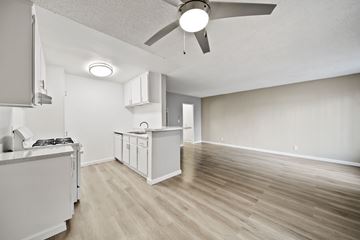 North Hills apartment for rent - A modern kitchen with a white cabinet and a wooden floor.