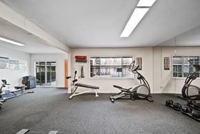 North Hills apartment for rent - A gym with a variety of equipment including treadmills, weights, and exercise bikes.