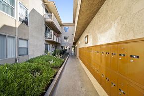 Panorama City apartment for rent - A long hallway with a row of lockers on the right.