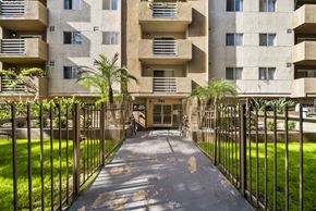 Los Angeles apartment for rent - A concrete building with a gate in front of it.