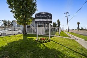 San Bernardino apartment for rent - A sign for Parc Mountain View Apartment Homes stands in front of a fence.