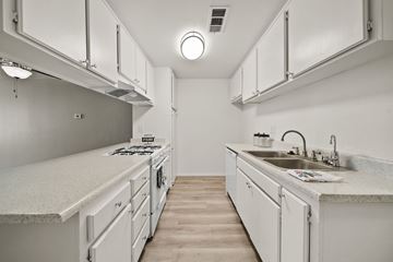 Lancaster apartment for rent - A white kitchen with a sink and a stove.