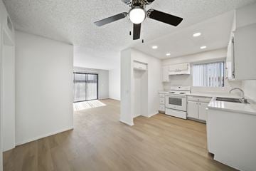 Palmdale apartment for rent - A white kitchen with a fan on the ceiling.