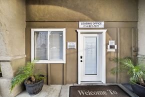 Cypress apartment for rent - A leasing office with a welcome mat and a door.