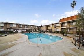 Cypress apartment for rent - A swimming pool in a courtyard surrounded by apartment buildings.