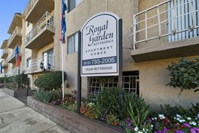 Van Nuys apartment for rent - A sign for Royal Garden Apartment Homes is displayed in front of a building.