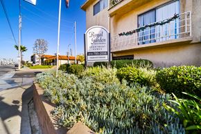 Van Nuys apartment for rent - A sign for Royal Garden Apartments stands in front of a building.