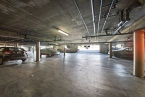 Van Nuys apartment for rent - A parking garage with cars parked and a concrete floor.