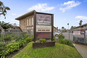 North Hollywood apartment for rent - A sign for the Royal Garden Apartments stands in front of a building.